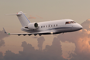 Private jet in the air with clouds in the background