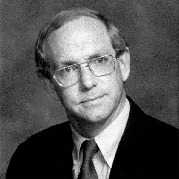 headshot of man wearing glasses