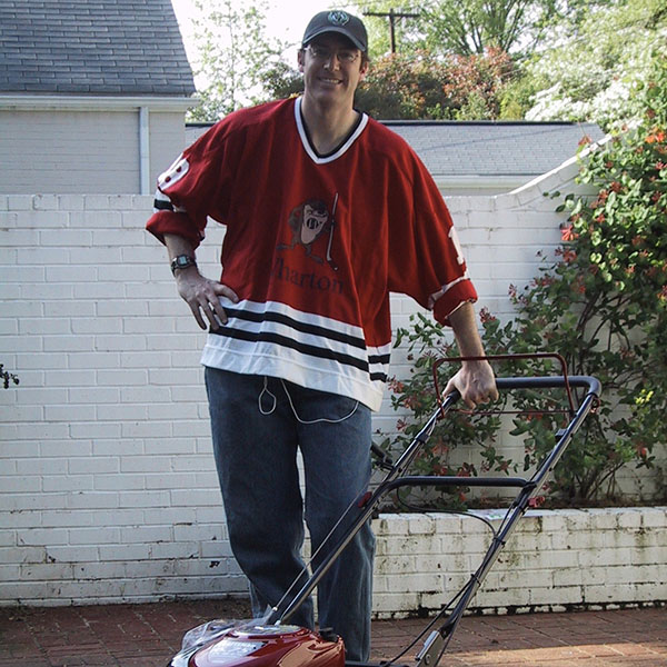 man standing with lawn mower